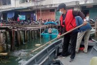Petugas Dinas Lingkungan Hidup Kota Tanjungpinang membersihkan sampah yang ada di laut. Foto: Istimewa