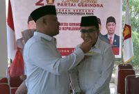 Ketua DPD Gerindra Kepri Iman Sutiawan menyuapkan tumpeng ke salah satu kader. Foto: Istimewa 