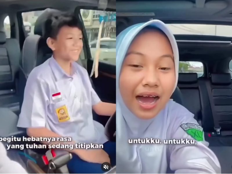 Viral di media sosial anak SMP yang masih mengenakan seragam putih biru menyetir mobil dengan sangat asyik sambil merekam video. Foto: Tangkapan Layar
