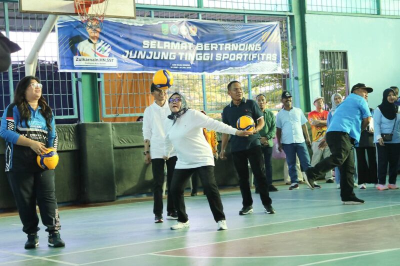 Ketua TP-PKK Batam Hj. Erlita Amsakar melakukan servis bola pertama sebagai tanda dibukanya Kejuaraan Voli 2025. Foto: INIKEPRI.COM