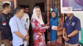 Bupati Natuna, Cen Sui Lan, secara simbolis menyerahkan Bantuan Sosial Tunai (BST) kepada salah satu lansia penerima manfaat di Kantor Pos Ranai, Kecamatan Bunguran Timur, Jumat (20/6/2025). Kegiatan ini merupakan bagian dari upaya pemerintah daerah dalam menanggulangi kemiskinan ekstrem di wilayah Natuna. Turut mendampingi sejumlah pejabat daerah, petugas Pos Indonesia, serta aparat keamanan setempat. Foto: Faturrahman/HK