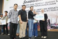Wali Kota Batam, Amsakar Achmad, menyerahkan santunan kepada ahli waris saat silaturahmi dengan RT dan RW di Sagulung. Foto: INIKEPRI.COM/Media Center Batam 