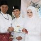 Kepala Kemenag Tanjungpinang Erizal menyerahkan buku nikah kepada pengantin. Foto: INIKEPRI.COM