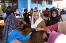 Bupati Natuna Cen Sui Lan turun langsung melayani warga yang berbelanja di Pasar Pangan Murah di Kelarik, Kecamatan Bunguran Timur. Foto: Sar/acikepri.com
