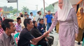 Bupati Natuna Cen Sui Lan saat menyerahkan bantuan sosial bagi masyarakat miskin ekstrem dan lanjut usia (lansia) tahap II di Kantor Pos Ranai. Foto: INIKEPRI.COM